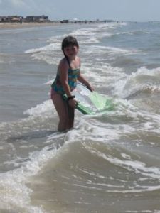 Kamryn loaned us her boogie board.  Madie is determined to surf those waves!